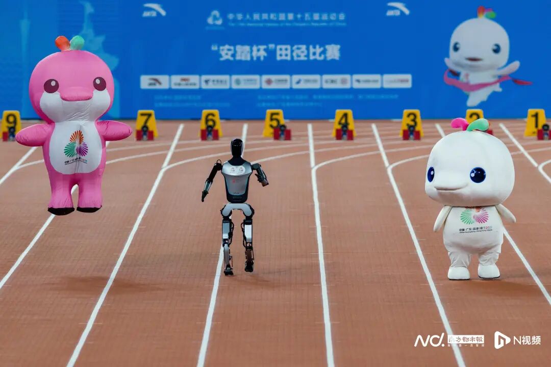 11月17日,广东奥体中心,十五运会田径项目赛前暖场活动,吉祥物组合“喜洋洋”“乐融融”与人形机器人Walker S2进行趣味百米赛跑,上演了一场萌翻全场的“人吉大战”。本届全运会,“喜洋洋”“乐融融”凭借超萌外表和超“E”属性爆火出圈,赛场之内,“显眼包”无处不在,名场面层出不穷,赛场之外,带动衍生周边产品销售一路飙升,甚至“一豚难求”。 11月17日,广东奥体中心,十五运会田径项目赛前暖场活动,吉祥物组合“喜洋洋”“乐融融”与人形机器人Walker S2进行趣味百米赛跑,上演了一场萌翻全场的“人吉大战”。本届全运会,“喜洋洋”“乐融融”凭借超萌外表和超“E”属性爆火出圈,赛场之内,“显眼包”无处不在,名场面层出不穷,赛场之外,带动衍生周边产品销售一路飙升,甚至“一豚难求”。